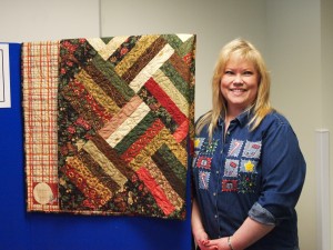 Sandra Gram wins one of the quilts donated in the annual employee potluck.