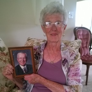 Senior woman holding photo of husband