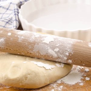 Flour on a rolling pin ready to roll out pie dough