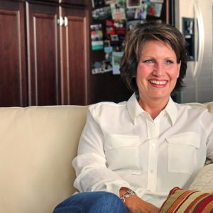 Woman sitting on couch and smiling