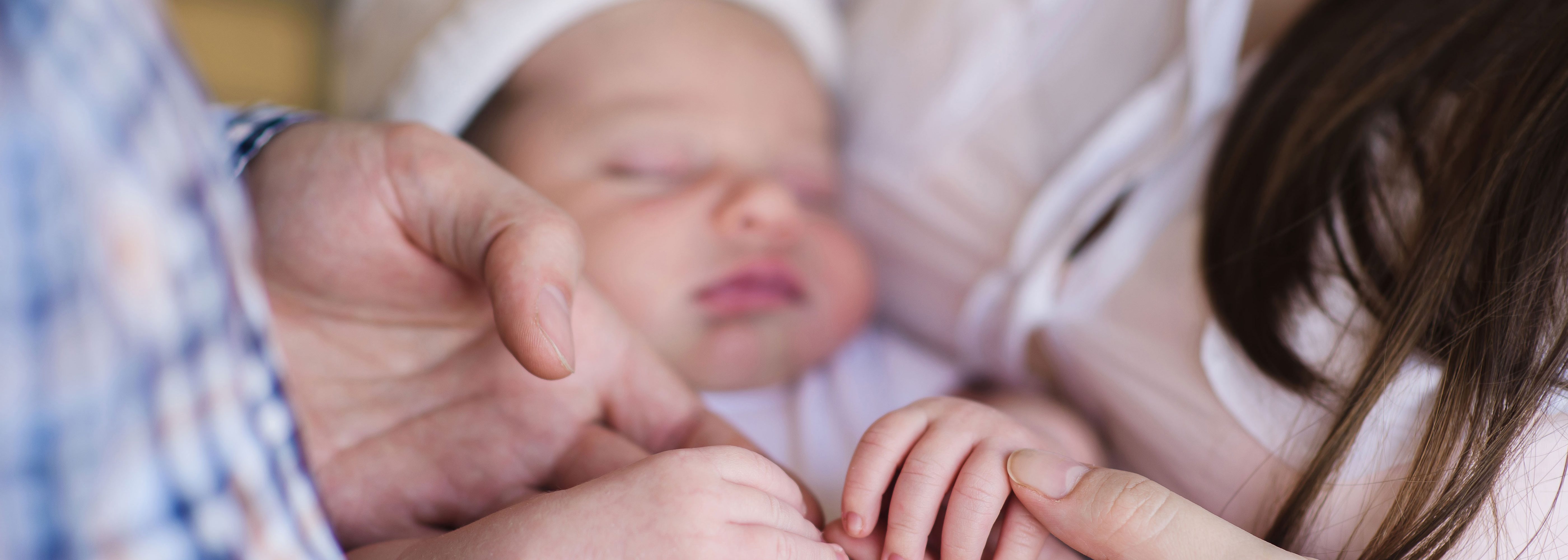 Parents holding baby