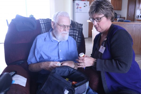 Bob and Judy Hendry, Hospice of the Red River Valley registered nurse, review medications.