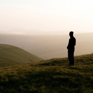 Silhouette of person on a hill