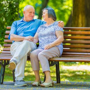 couple sitting on park bench