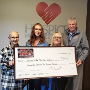 Ole's Ride committee members present a check to Hospice of the Red River Valley team member.