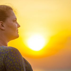 profile of woman with sunset in the background