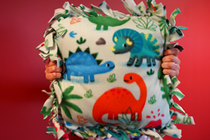 homemade pillow with dinosaurs on it