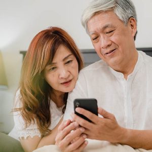 middle aged couple looking at cell phone