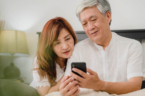middle aged couple looking at cell phone
