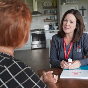 Hospice of the Red River Valley nurse talks with a caregiver