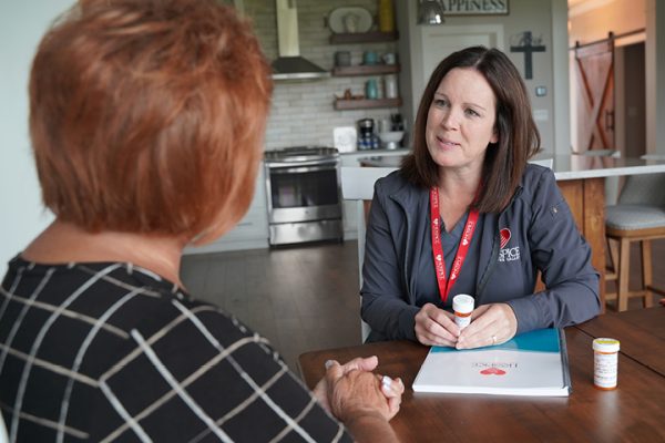 Hospice of the Red River Valley nurse talks with a caregiver