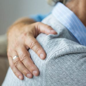 Man's hand on woman's back providing comfort