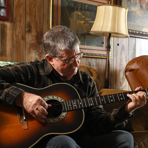 Lloyd Stoll playing guitar.